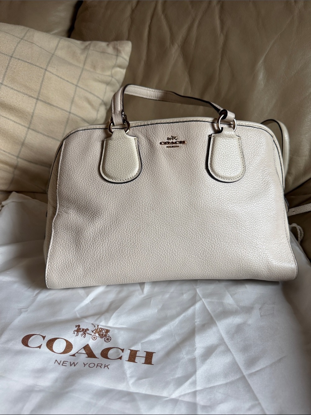 COACH Pebbled Leather Satchel in off-white or cream.